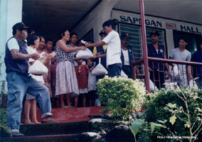 Chairman Buddy and his tanods giving away gifts to some constituents